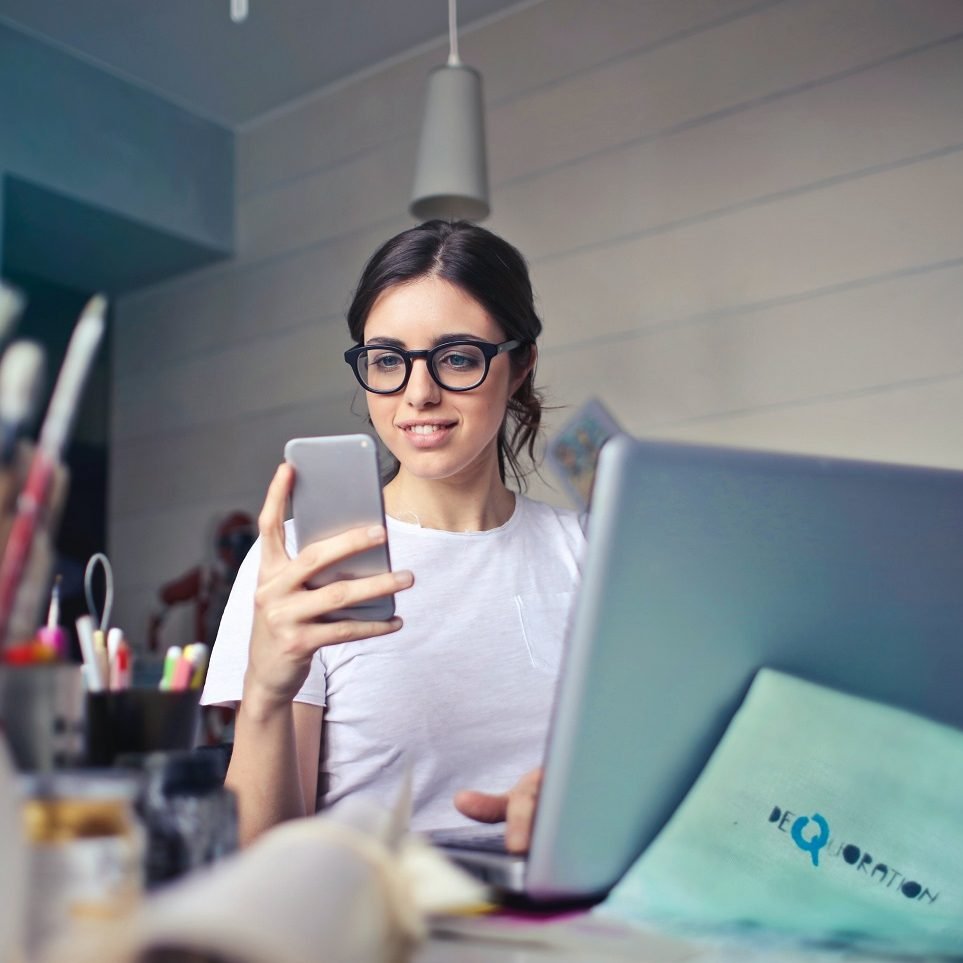marketing tips for small business Photo by Andrea Piacquadio: https://www.pexels.com/photo/woman-in-white-t-shirt-holding-smartphone-in-front-of-laptop-914931/